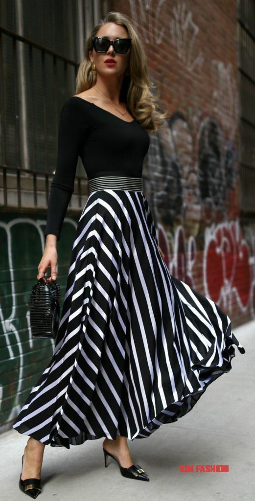 Black and white striped skirt Outfit for Wedding Guest with Black blouse Black heels and a Black clutch Purse Skirt Outfit for Wedding Guest