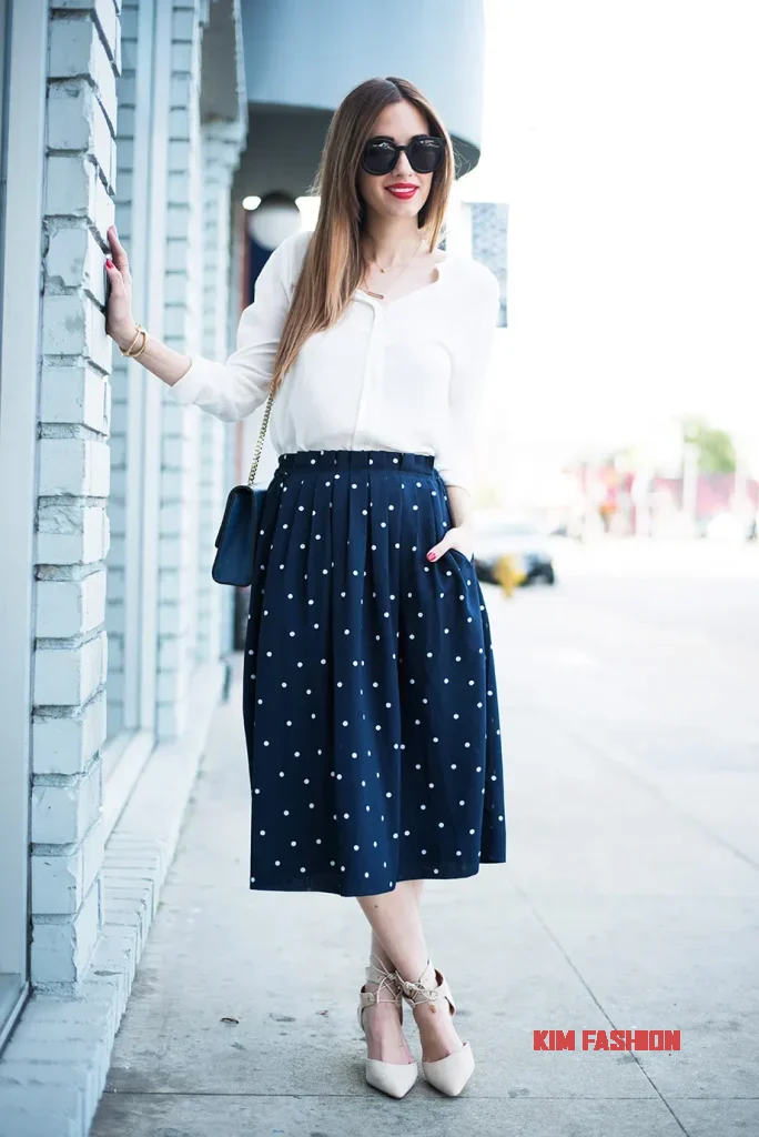 Navy polka dot skirt
Outfit for Wedding Guest with
White off-the-shoulder top, Navy sandals and a 
White handbag