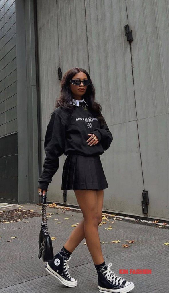 Black tennis pleated mini skirt with black pull over sweater